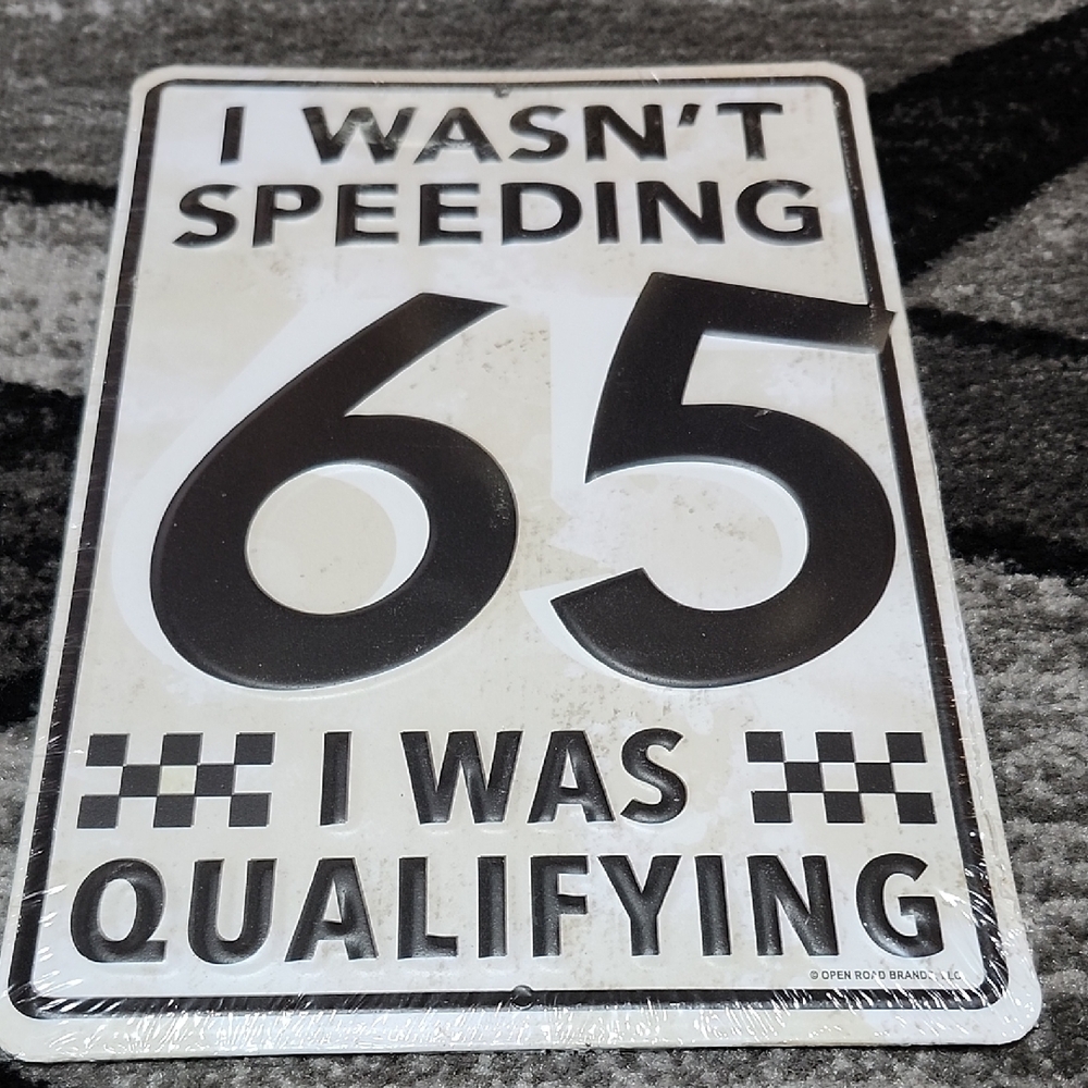 VINTAGE EMBOSSED METAL " I WASN"T SPEEDING I WAS QUALIFYING" OPENROAD WALL SIGN